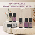 Gentlemen's water-soluble aromatherapy essential oil set displayed on white stone pedestals with floral decorations.